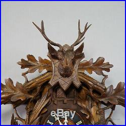 Black forest carved wood cuckoo and quail clock with deer head