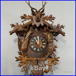 Black forest carved wood cuckoo and quail clock with deer head