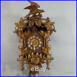 Black forest carved wood cuckoo clock with bird on top