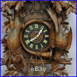 Black forest carved wood cuckoo clock with large eagle on top